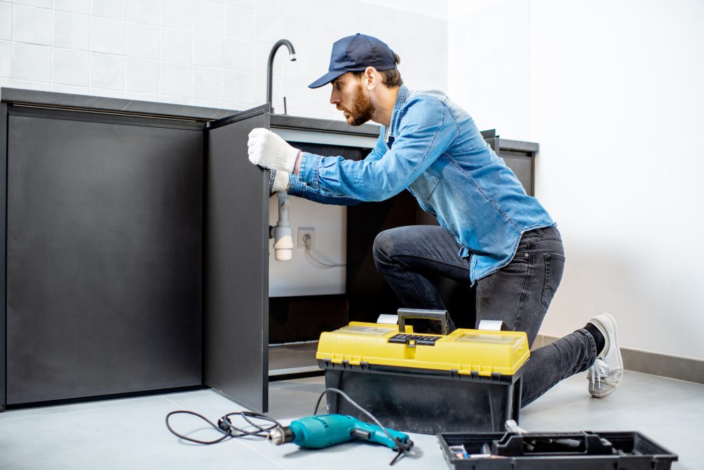 Man repairing kitchen furniture